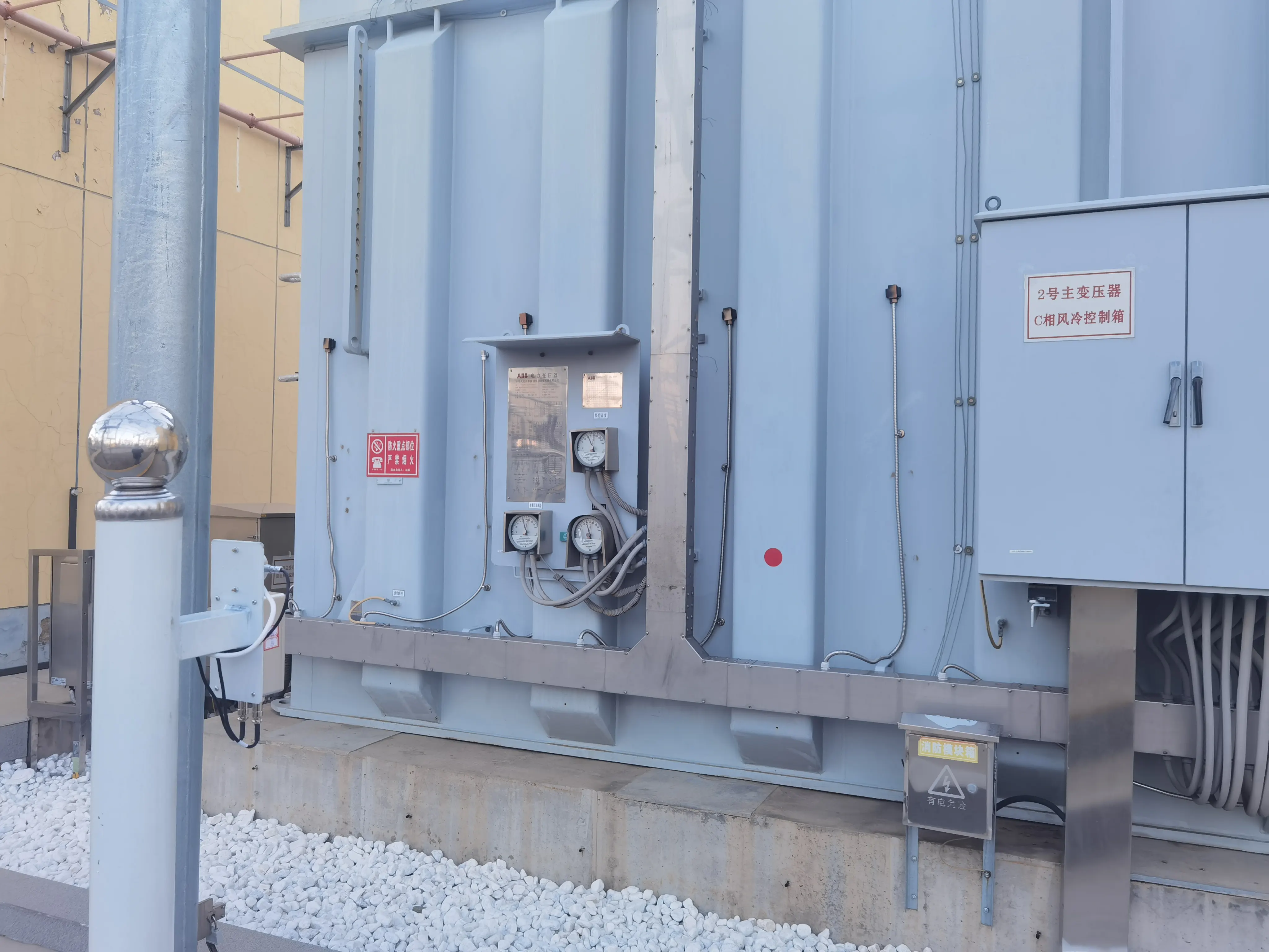 Utility engineer reviewing transformer condition at an outdoor substation