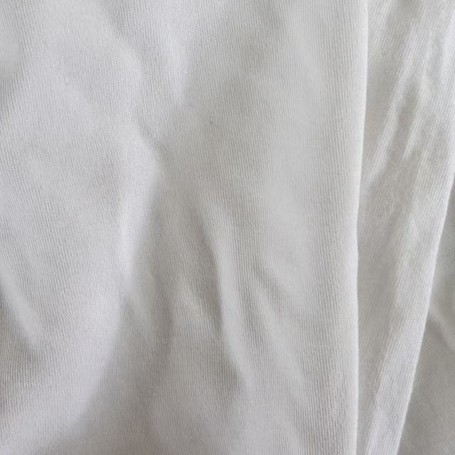 Close-up of Grade A white T-shirt knit rags showing recycled cotton fiber texture, low-lint surface, ideal for precision cleaning tasks.