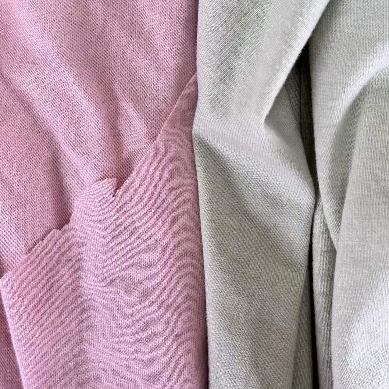 Close-up of light color mixed T-shirt knit rags showing assorted light shades and absorbent knit texture.