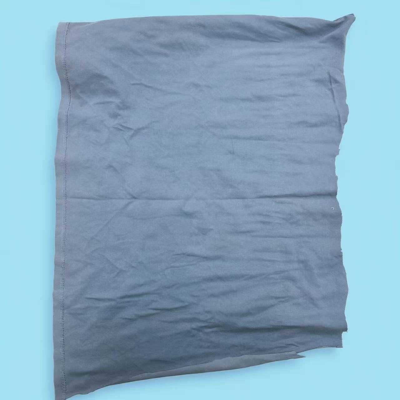 Close-up of mixed colored T-shirt knit rags with deep color blend, ideal for stain concealment in dirty environments.