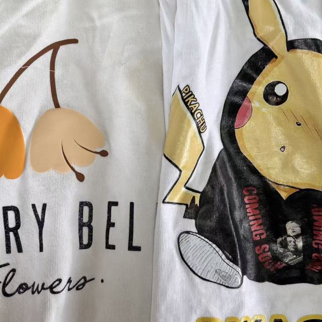 Close-up of printed white T-shirt knit rags showing white background with printed graphics, stain visibility on unprinted areas.