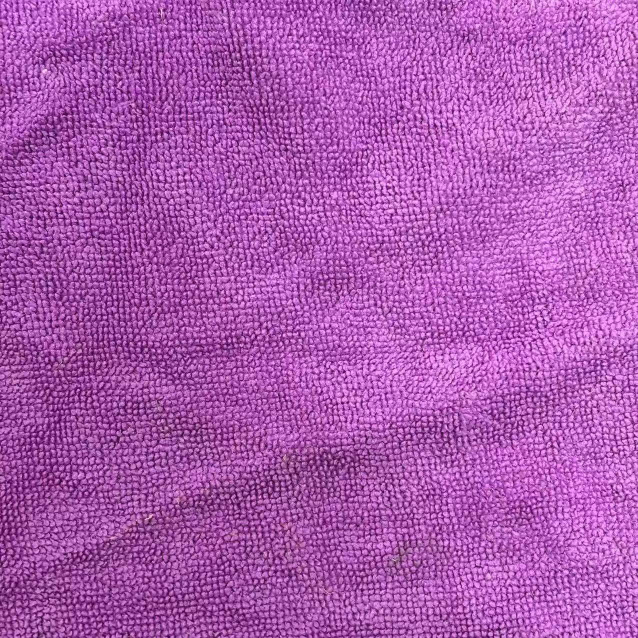 Close-up of colored terry toweling rags showing prominent looped pile texture, high absorbency for heavy oil and coolant.