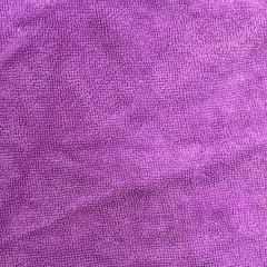 Close-up of colored terry toweling rags showing prominent looped pile texture, high absorbency for heavy oil and coolant.