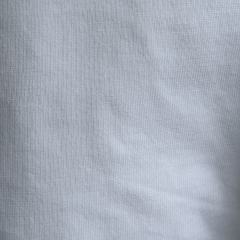 Close-up of custom-cut new cotton wipers showing tailored size and clean edges, perfect for automated processes.