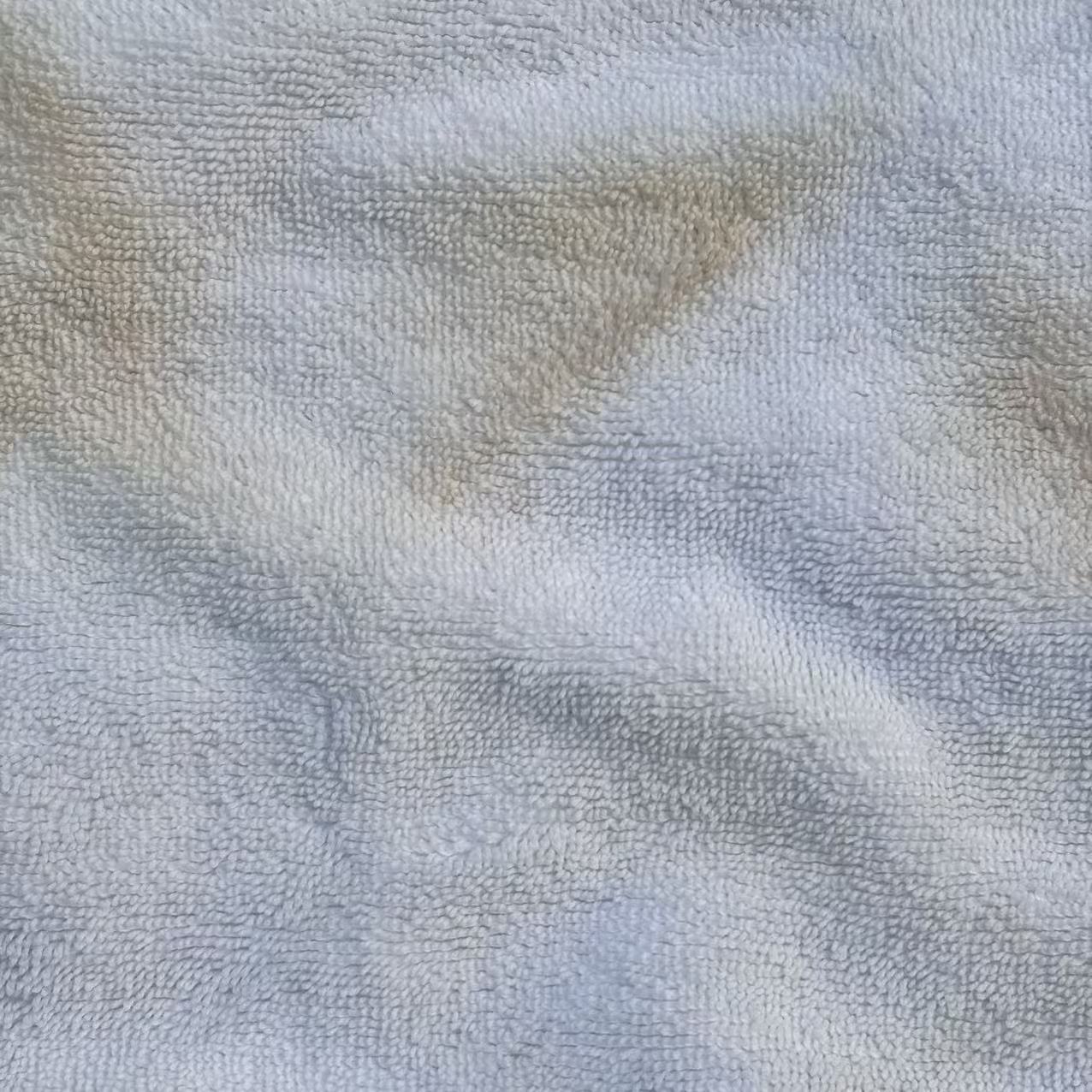 Close-up of Grade B white terry toweling rags showing good loop structure, suitable for everyday industrial cleaning.