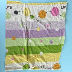 Close-up of mixed colored sheeting rags showing assorted light colors and smooth weave, ideal for versatile cleaning.