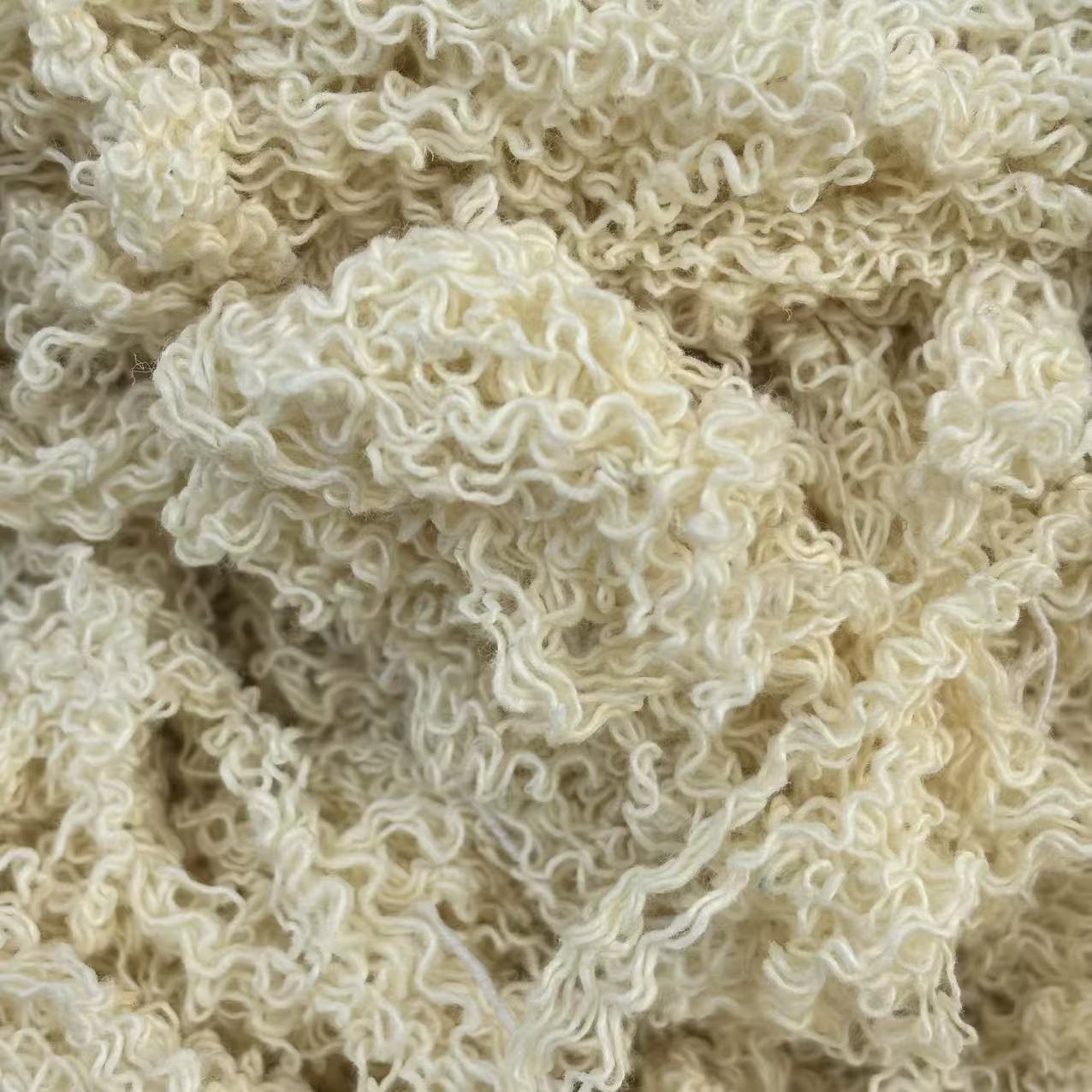 Close-up of off-white hand-sorted cotton yarn waste showing natural color fibers, effective for general maintenance.