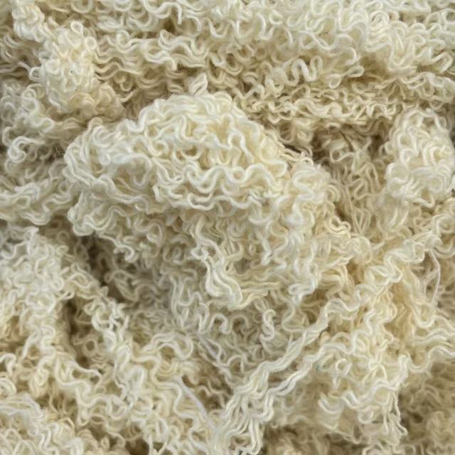 Close-up of off-white hand-sorted cotton yarn waste showing natural color fibers, effective for general maintenance.