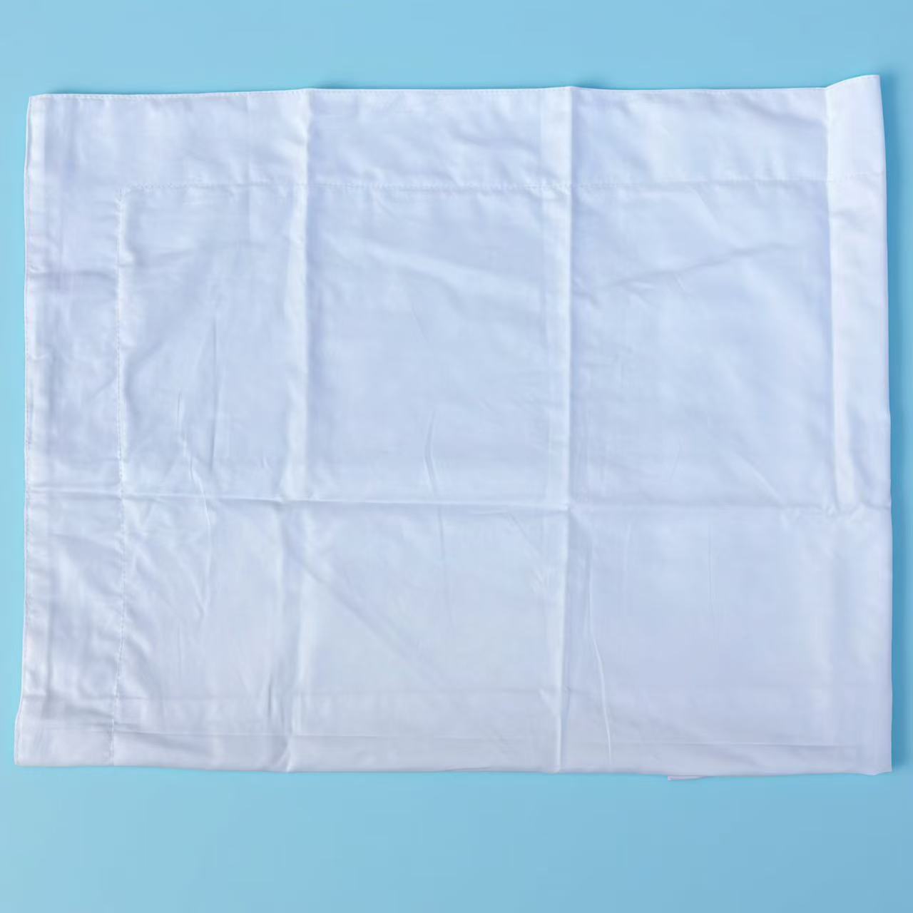 Close-up of pre-cut new cotton wipers showing precision-cut edge and smooth woven surface, low-lint for critical cleaning.