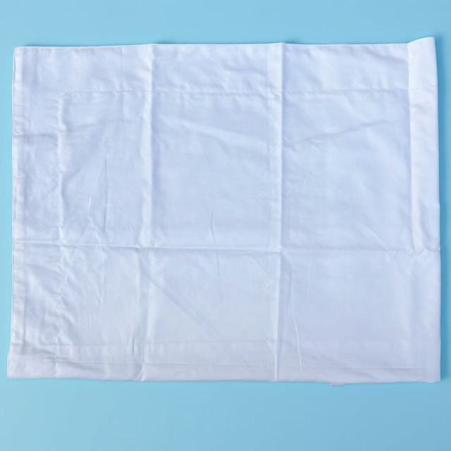 Close-up of pre-cut new cotton wipers showing precision-cut edge and smooth woven surface, low-lint for critical cleaning.