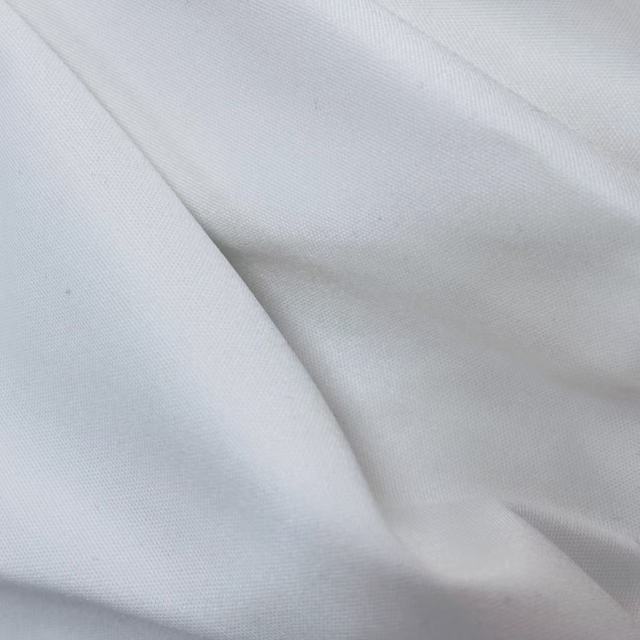Close-up of pre-cut new cotton wipers showing precision-cut edge and smooth woven surface, low-lint for critical cleaning.