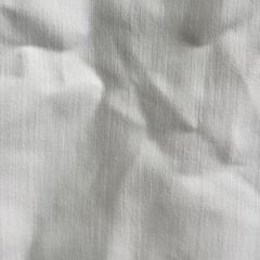 Close-up of premium white sheeting rags showing smooth plain weave, low-lint linen fabric for scratch-free cleaning.