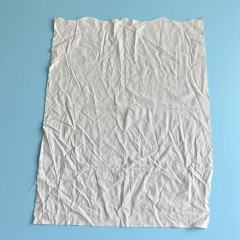 Close-up of premium white sheeting rags showing smooth plain weave, low-lint linen fabric for scratch-free cleaning.