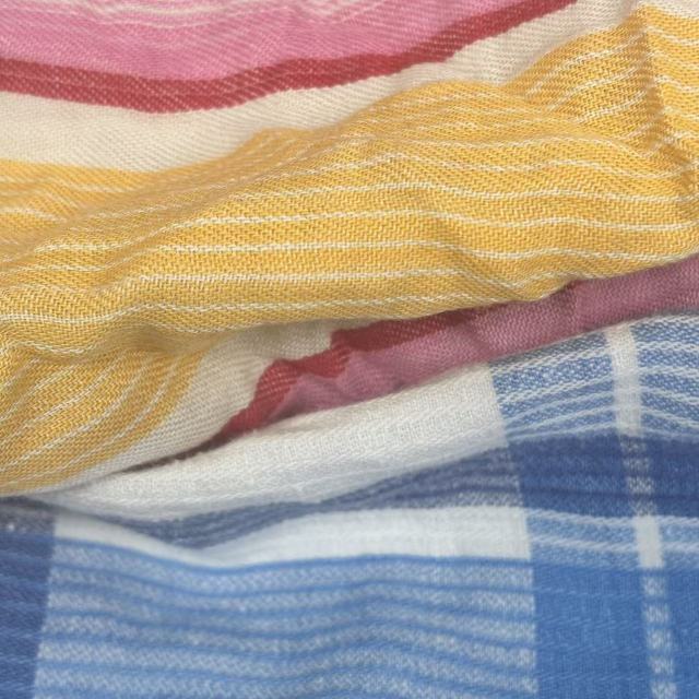 Close-up of uncut white sheeting rags showing full sheet format, smooth fabric for precise custom sizing.