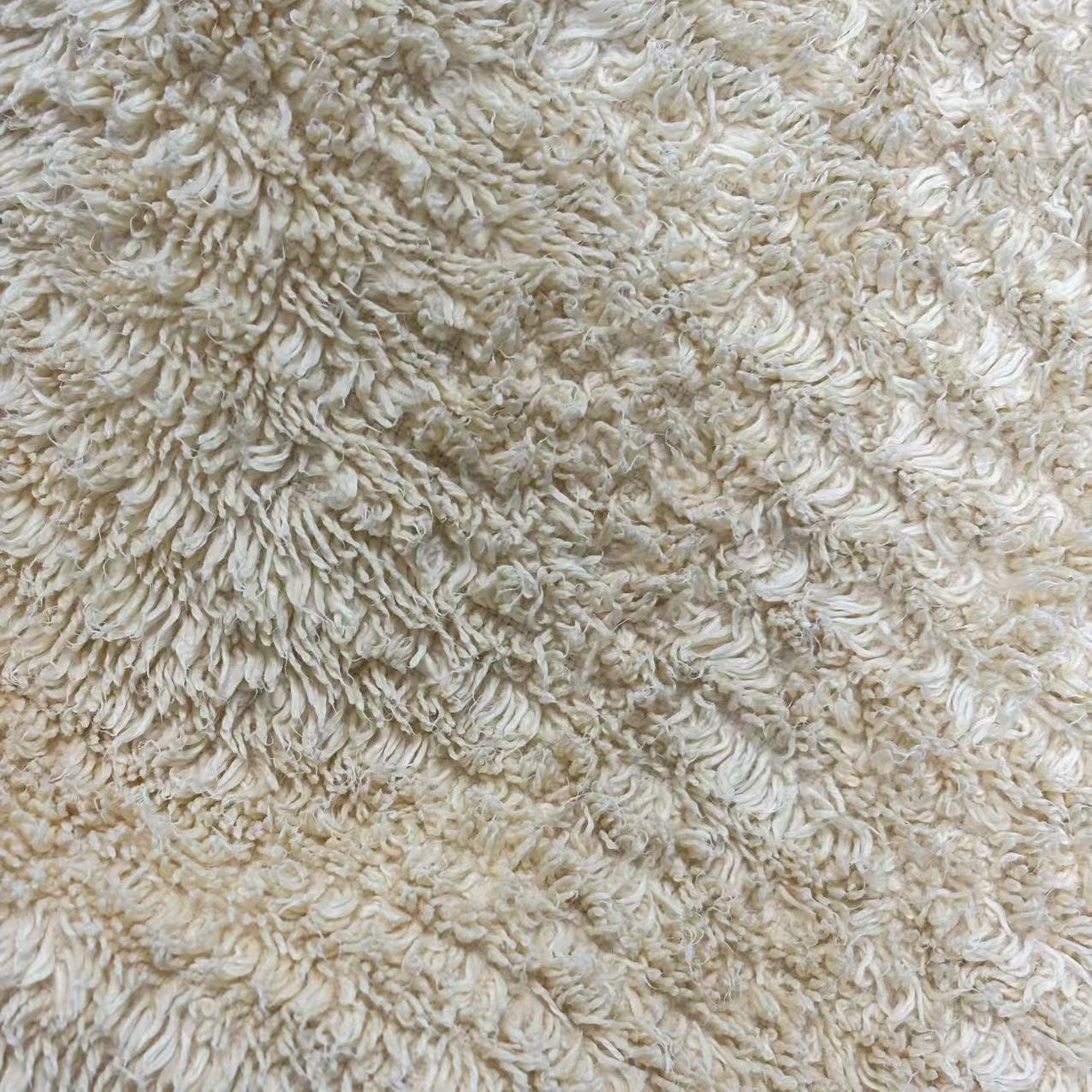 Close-up of uncut colored terry toweling rags showing full towel size and absorbent loop texture.