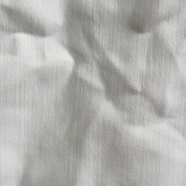 Close-up of uncut white sheeting rags showing full sheet format, smooth fabric for precise custom sizing.