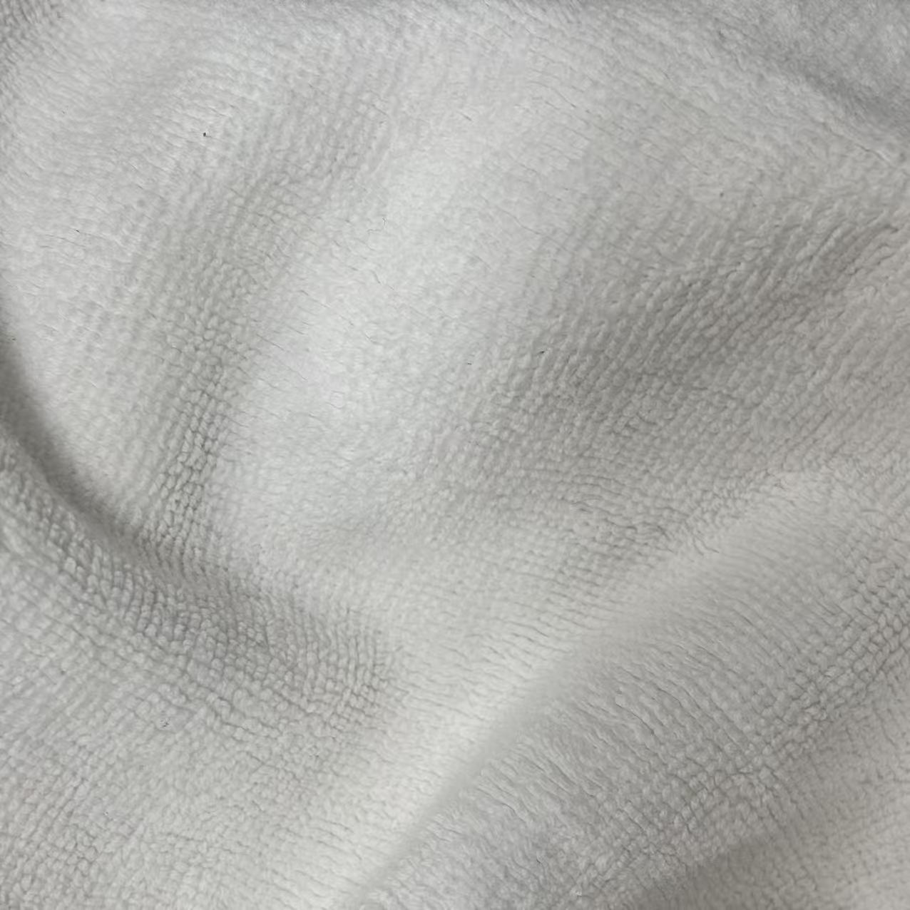 Close-up of uncut white terry toweling rags showing pristine white loops, ideal for sanitary and precision tasks.