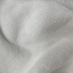 Close-up of uncut white terry toweling rags showing pristine white loops, ideal for sanitary and precision tasks.