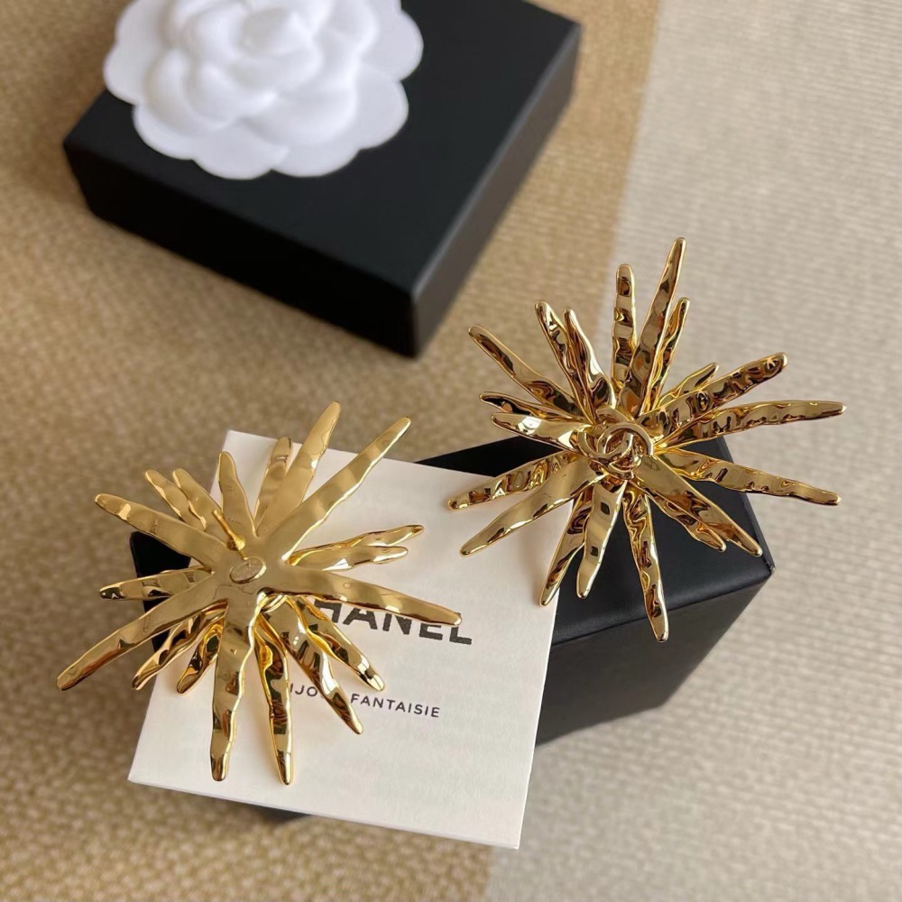 CHANEL GOLD TEXTURED STARBURST METAL EARRINGS