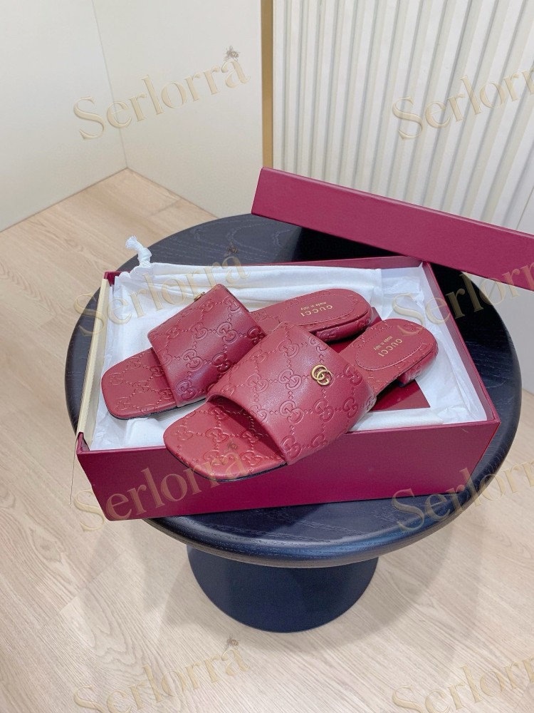 GUCCI ALL-OVER GG EMBOSSED LEATHER DOUBLE G SLIDE SANDALS