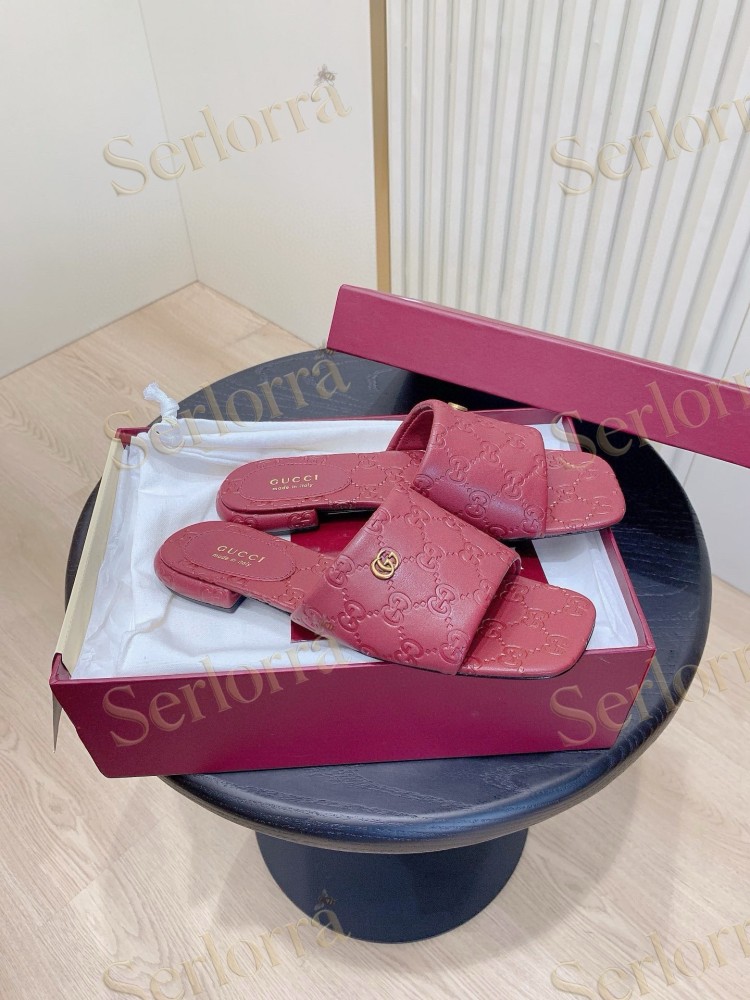 GUCCI ALL-OVER GG EMBOSSED LEATHER DOUBLE G SLIDE SANDALS