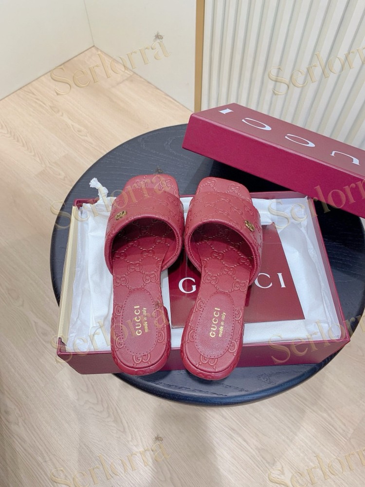 GUCCI ALL-OVER GG EMBOSSED LEATHER DOUBLE G SLIDE SANDALS