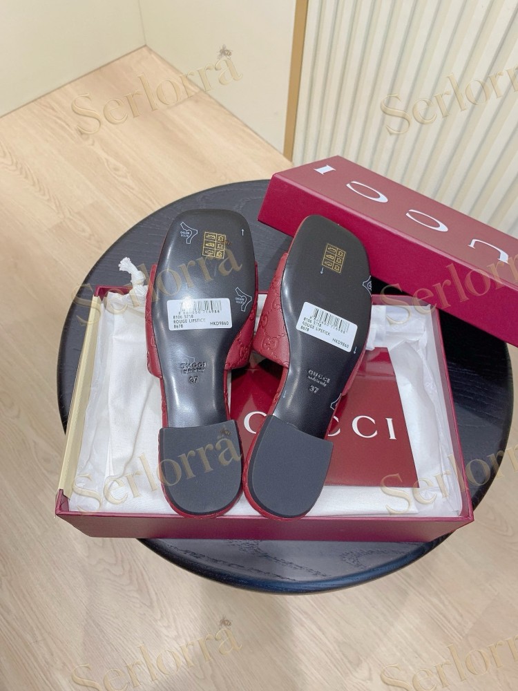 GUCCI ALL-OVER GG EMBOSSED LEATHER DOUBLE G SLIDE SANDALS