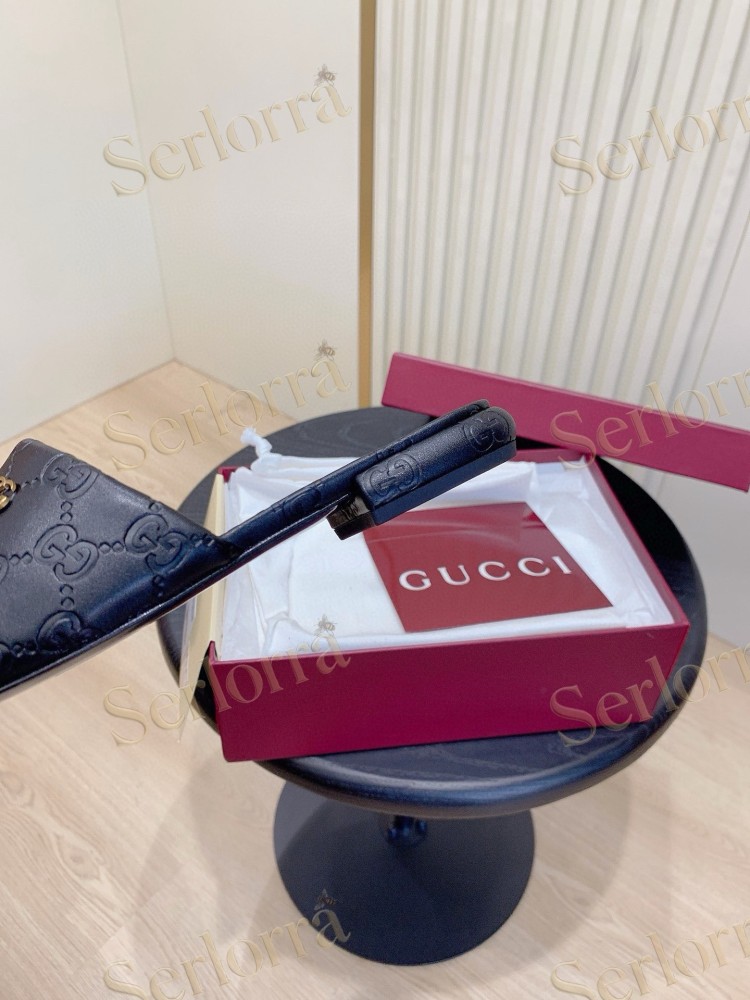 GUCCI ALL-OVER GG EMBOSSED LEATHER DOUBLE G SLIDE SANDALS