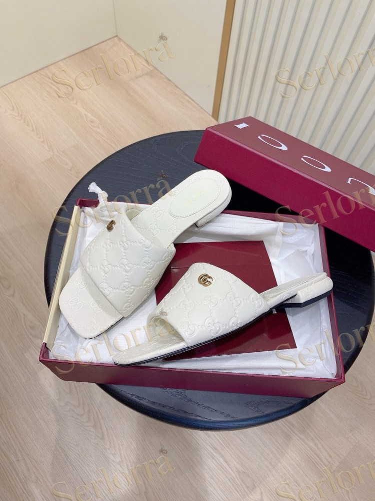 GUCCI ALL-OVER GG EMBOSSED LEATHER DOUBLE G SLIDE SANDALS