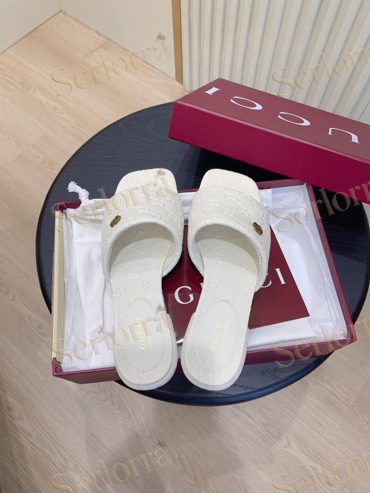 GUCCI ALL-OVER GG EMBOSSED LEATHER DOUBLE G SLIDE SANDALS