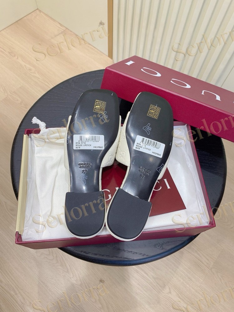 GUCCI ALL-OVER GG EMBOSSED LEATHER DOUBLE G SLIDE SANDALS