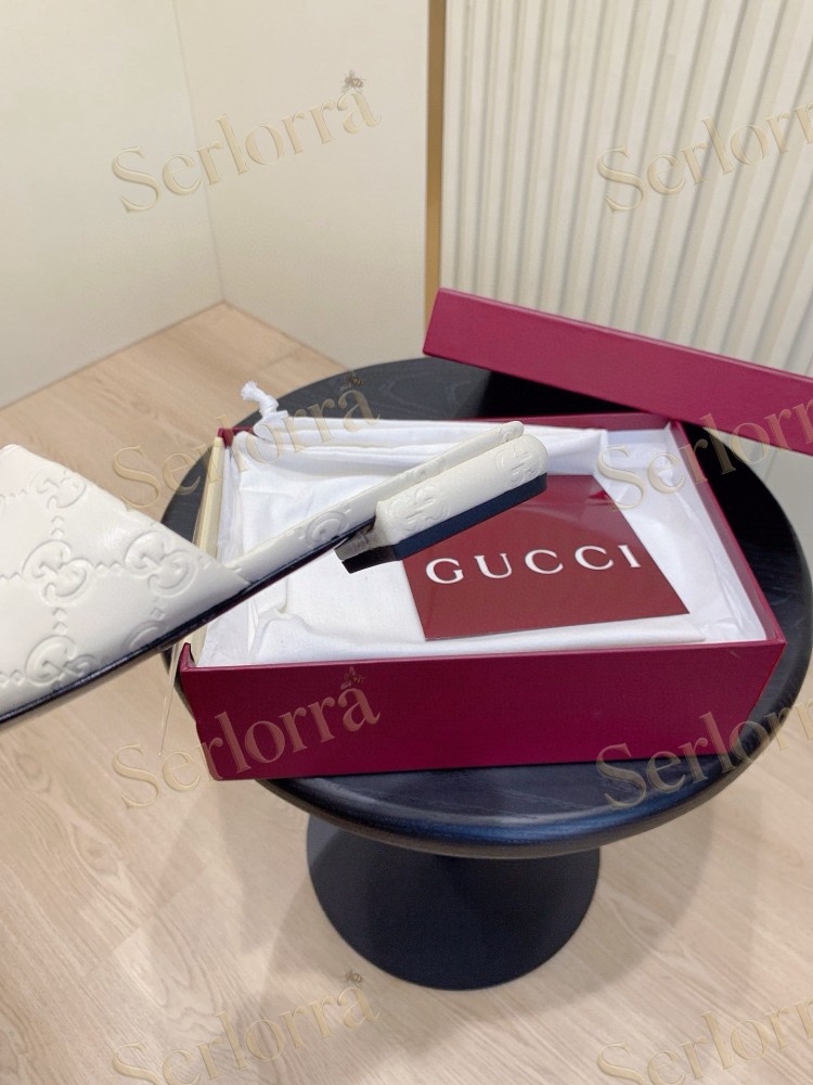 GUCCI ALL-OVER GG EMBOSSED LEATHER DOUBLE G SLIDE SANDALS