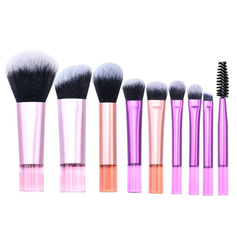Makeup brush set with crystal handle, including powder brush, contour brush, blush brush, and eyeshadow brush. 10 brushes in a portable set.