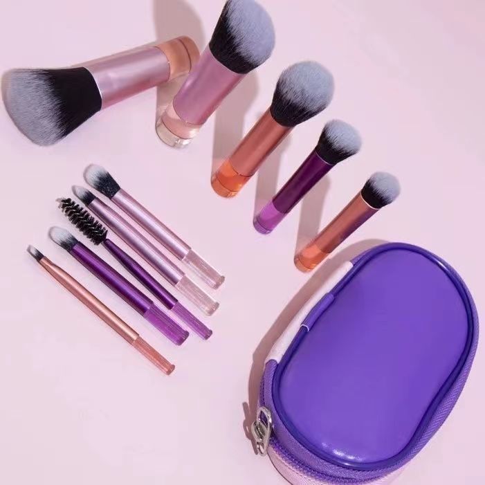 Makeup brush set with crystal handle, including powder brush, contour brush, blush brush, and eyeshadow brush. 10 brushes in a portable set.