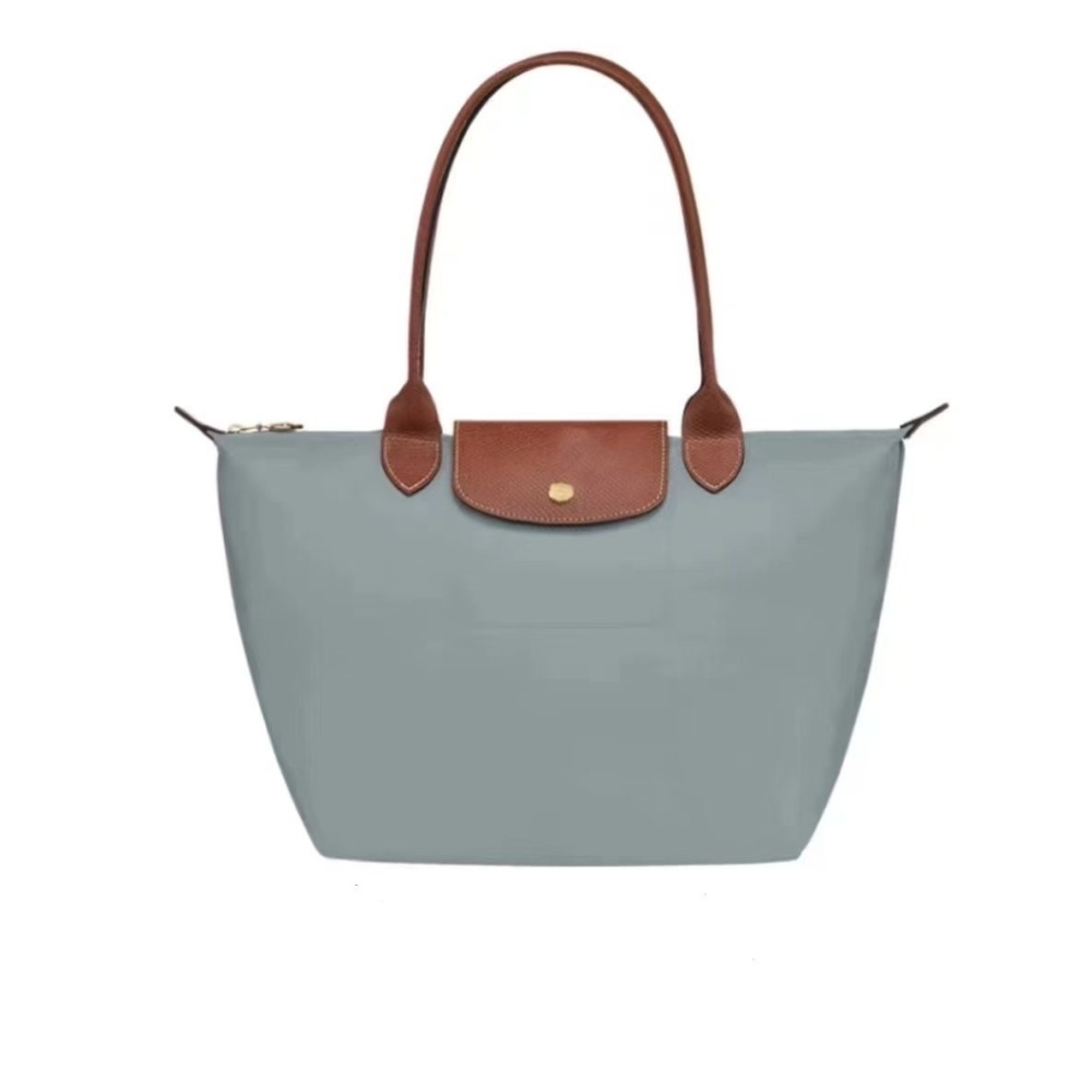 LONGCHAMP medium tote bag with gold hardware, snap buttons, and zipper closure.