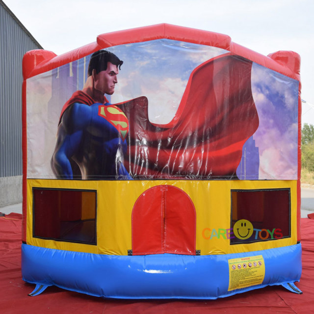 bounce house with Superman art pannel