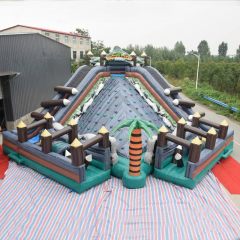 rocky island obstacle course with rock climbing slide