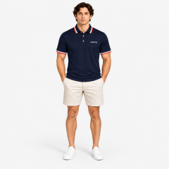 Man wearing a navy golf polo shirt with khaki shorts
