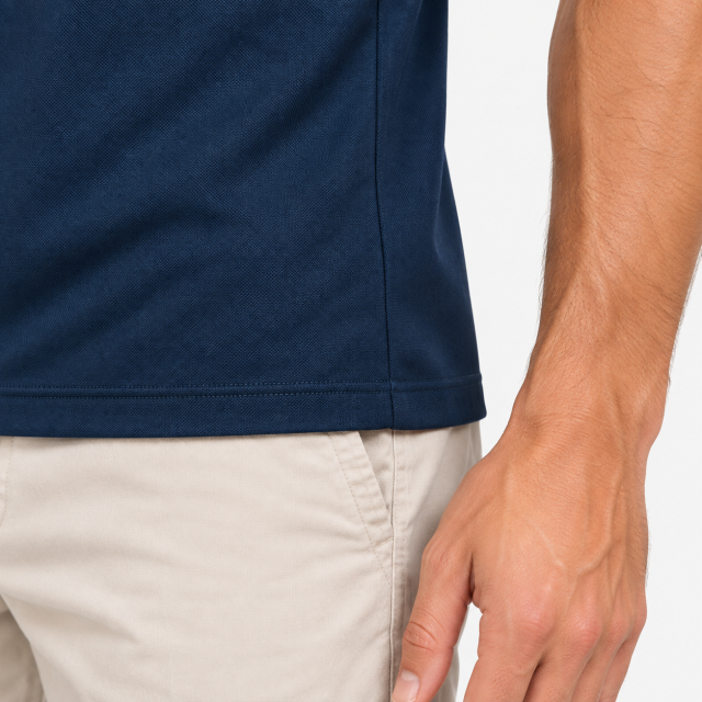 Men's navy golf polo shirt hem and fabric detail