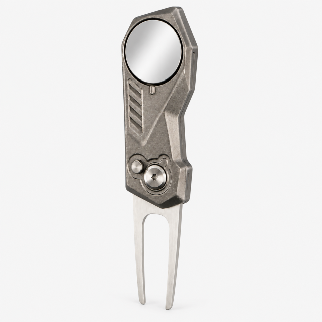 Two-prong metal golf divot tool with round ball marker, angled front view