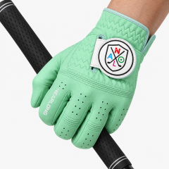 Mint green sheepskin golf glove gripping golf club with custom closure logo