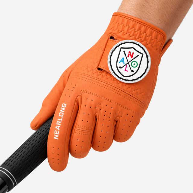Orange sheepskin golf glove gripping golf club with custom closure logo