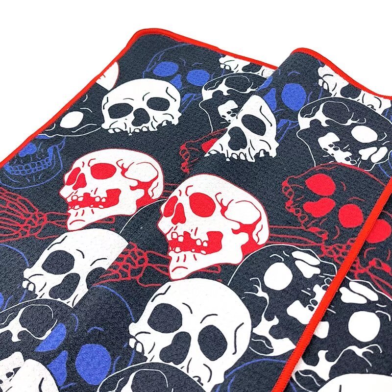 All-over print golf towel with skull pattern and red edge binding