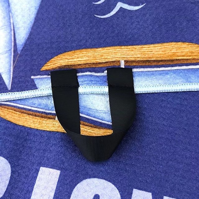 Golf club towel with center hanging loop for golf bag use