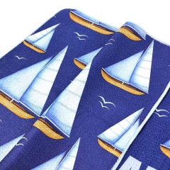 Branded golf towel with all-over sailboat pattern