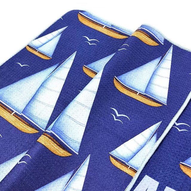 Branded golf towel with all-over sailboat pattern