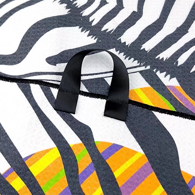 Golf tournament towel with center hanging loop and zebra print