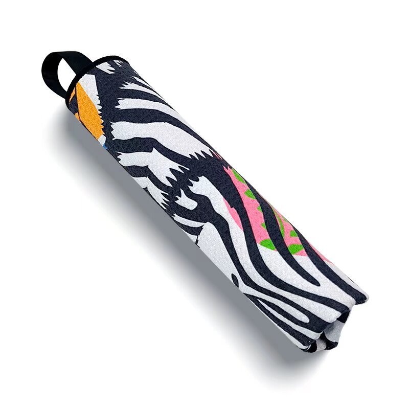 Rolled custom golf tournament towel with colorful zebra pattern
