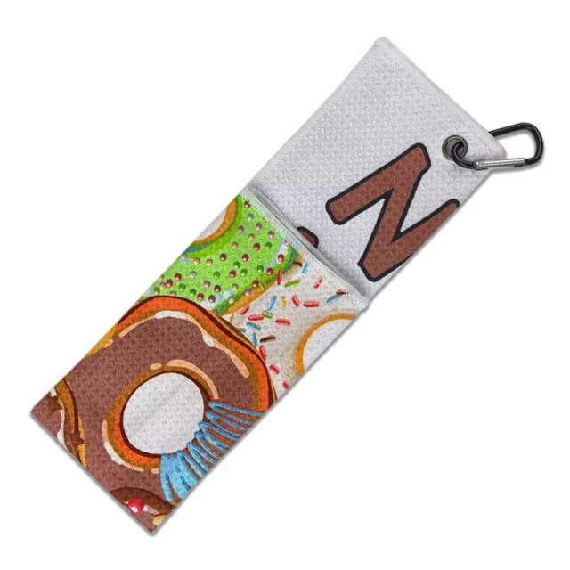 Folded personalized golf bag towel with donut print and clip