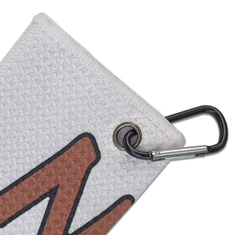 Golf towel with carabiner clip and reinforced metal grommet